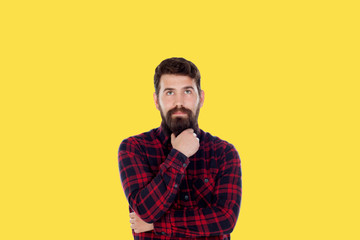 Fototapeta premium Hipster man with big beard on a yellow background