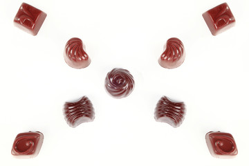 Closeup brown chocolate candy background. Isolated on a white background.