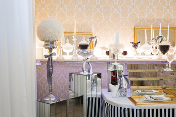 Delicious and tasty dessert table with cupcakes shots at reception closeup