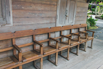Wooden chairs are arranged in rows.