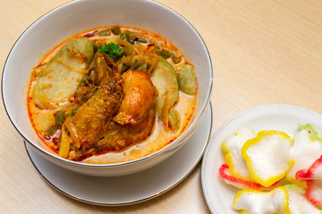 Indonesian or Malay food ketupat sayur or lontong sayur, rice cake with chicken curry on a bowl close up