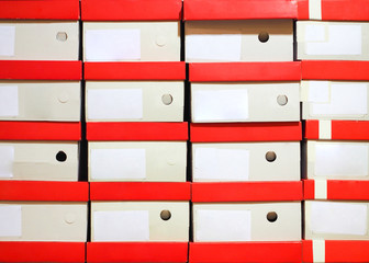 Stock of footwear boxes stacked in store.