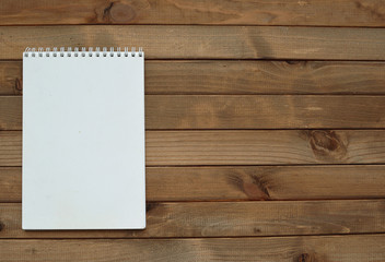 Blank notepad on wooden background. Empty space.