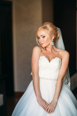 Morning of beautiful woman. Wedding day. Bride in white dress. Wedding dress. Bride dressed in hotel