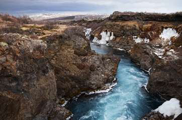 Glacial river of Iceland from blue water amid lava fields