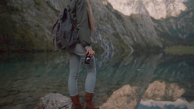 Young woman with a hat by the lake