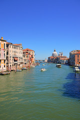 Fototapeta na wymiar Venetian canal detail with small boat in summer