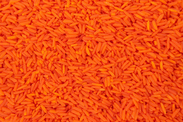Orange rice from above view for texture backgrounds