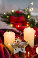Composition: red roses with boxwood, candles, a garlands , red blanket and star.