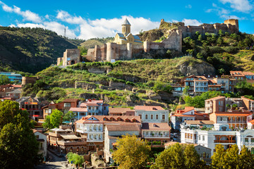 View on Tbilisi old town with famous old houses and balconies, Narikala fortress on top of the hill
