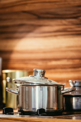 Steaming metal pot in the kitchen, wood