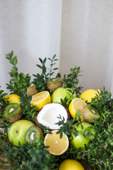 Bouquet of lemons, green apples, coconut, kiwi and boxwood