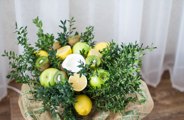 Bouquet of lemons, green apples, coconut, kiwi and boxwood