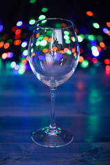 Alcohol cocktail for winter party. Cocktail ideas concept. Easy recipes for winter alcoholic cocktail drinks. Cocktail glass on defocused garland colorful lights. What to drink on christmas party