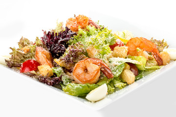 Caesar salad with shrimp. On white background