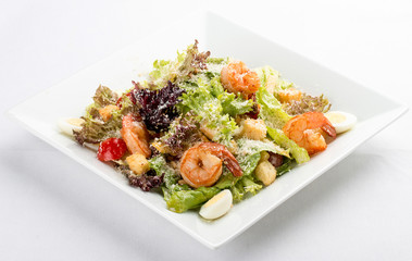 Caesar salad with shrimp. On white background