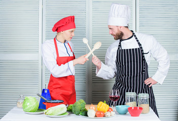 Woman and bearded man culinary show competitors. Who cook better. Ultimate cooking challenge. Culinary battle of two chefs. Couple compete in culinary arts. Kitchen rules. Culinary battle concept