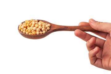 spoon in hand with yellow peas on white background
