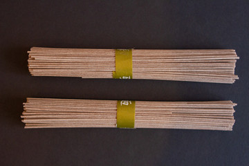 buns of noodles on a black background