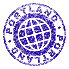 PORTLAND stamp print with grunge style. Blue vector rubber seal print of PORTLAND tag with grunge texture. Seal has words arranged by circle and planet symbol.