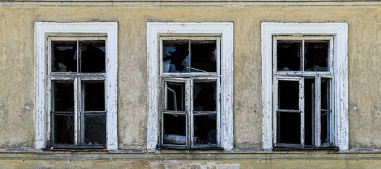 Old broken windows on an abandoned old building.
