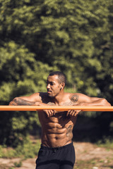 African-american muscular man taking break during morning workout