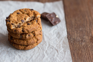 delicious crispy oatmeal cookies with chocolate chips on parchment