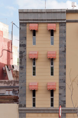 facade; window awnings and narrow windows