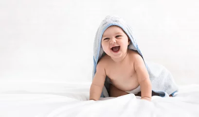 Fototapeten Cute little baby boy in hooded towel after bath © Prostock-studio