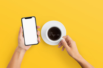 Woman holding mobile phone and coffee cup - Powered by Adobe