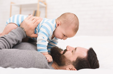 Newborn baby son with his happy father