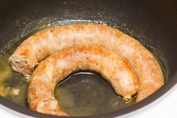 pieces of sausage are fried in fat