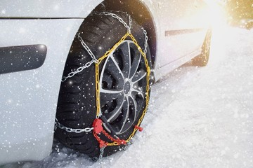 Tyre with chains, car in winter season on snow	