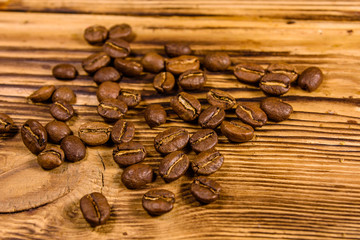 Scattered coffee beans on a wooden table