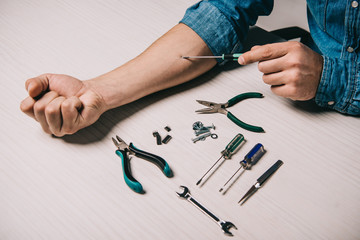 cropped view of man repairing hand with screwdriver