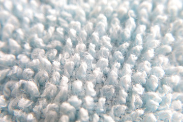 Fototapeta na wymiar Carpet fibers sweaters macro photo of a muddy surface out of focus background image.