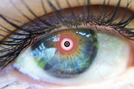 Eye of a man in a narcotic trance macro image of an expanded vision of the pupil blurred plan out of focus