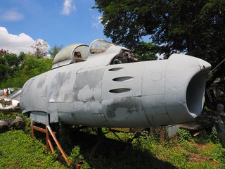 Decaying military plane on rusty support