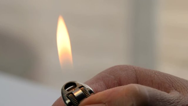 Close up of finger striking a lighter