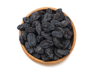 black raisins in wooden bowl isolated on white background. top view