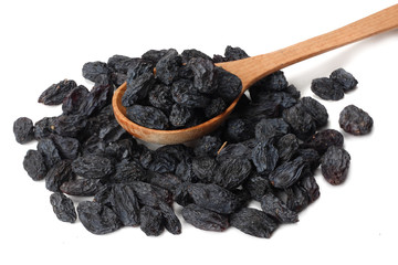 black raisins in wooden spoon isolated on white background