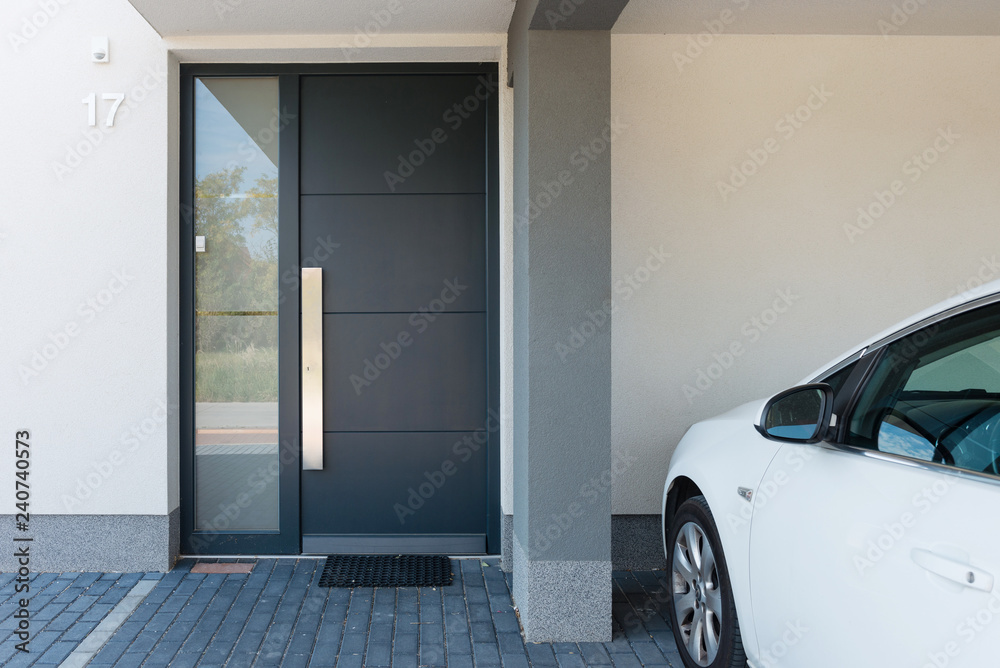 Wall mural modern house entrance with parking car next to it