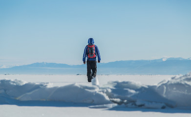 Naklejka na ściany i meble Man hiking on ice. Winter Landscape.