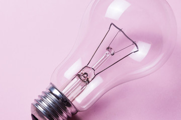 Light bulb closeup isolated on pink background.