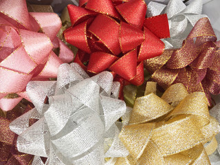background of colorful pile of ribbons for present and gift, stacking of colorful bows selling in the shop