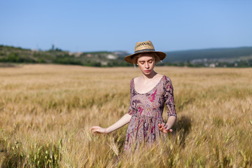 Naklejka na ściany i meble a woman farmer in field of wheat harvest