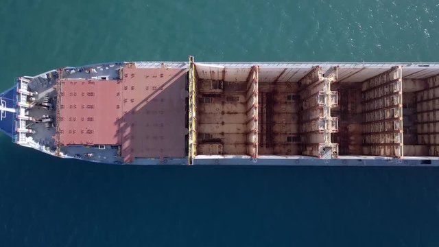 Empty container ship at sea - Top down aerial footage.