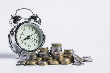 Coins with clock on white isolated background for business,finance,save concept.