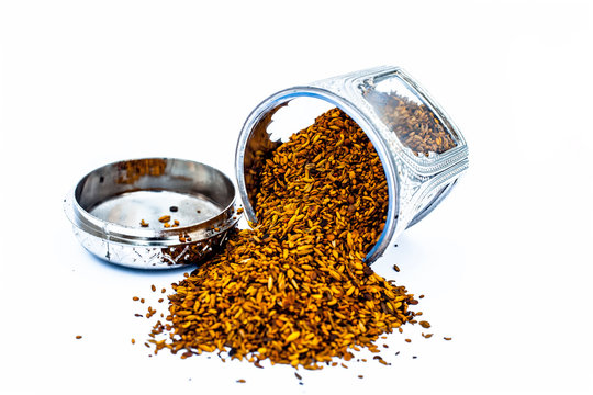 Close up of white or sliver colored shiny container used to store mukhwas  or mouth freshing snack in it isolated on white with mukhwas in it.