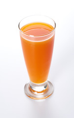 glass of fresh carrot juice isolated on white background